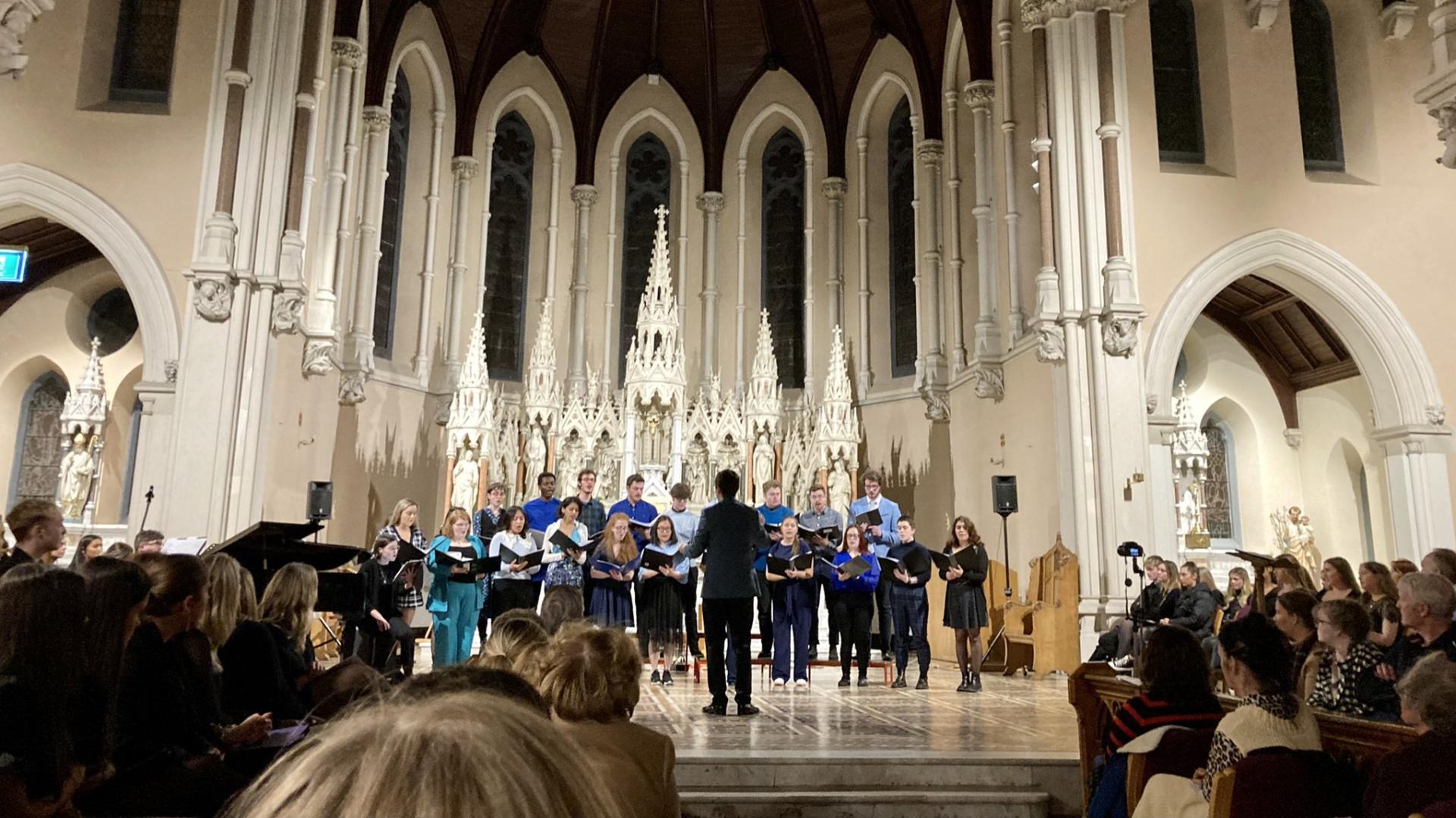 Shows DCU Chamber Choir performing in All Hallows in 2022